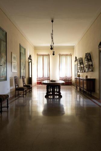a large room with a table and chairs in it at Castello di Lispida in Monselice