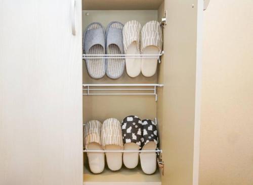 a closet filled with lots of pairs of shoes at Direct to Namba,Korean town201 in Osaka