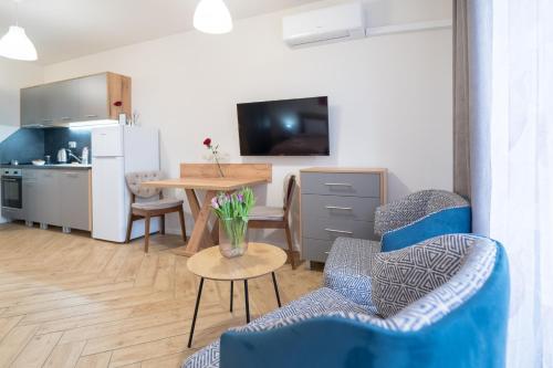 a living room with a table and chairs and a kitchen at WOW studios for rent - bul Montevideo 25A - B in Sofia
