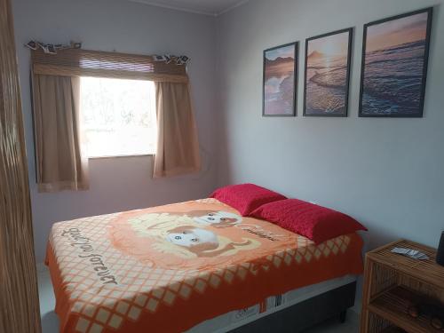 a bedroom with a bed with a teddy bear on it at Kitnets Renascer Beach in Guaibim