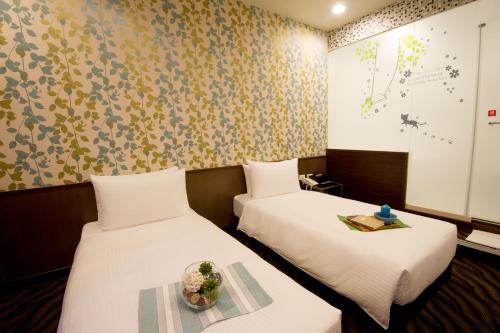 Postel nebo postele na pokoji v ubytování Moshamanla Hotel - Ximen