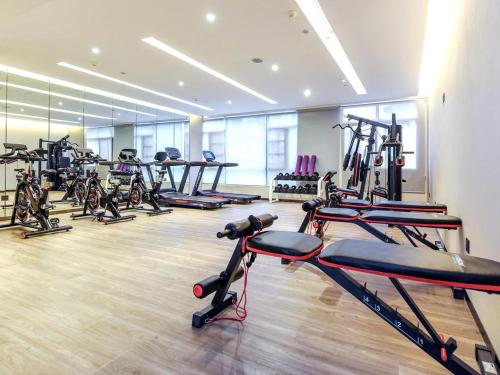 a gym with a row of treadms and machines at Lavande Hotel Nanchong Xihua Shida in Nanchong