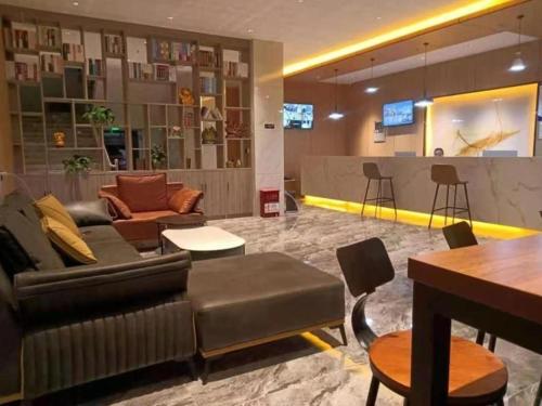 a lobby with a couch and chairs and a bar at Green Tree Inn Express Xizang Changdu Mangkang County in Markam