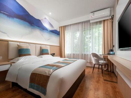 een hotelkamer met een groot bed en een flatscreen-tv bij VX Hotel Beijing Daxing Wufutang Metro Station Zhongke Dianshanggu in Donggaodi