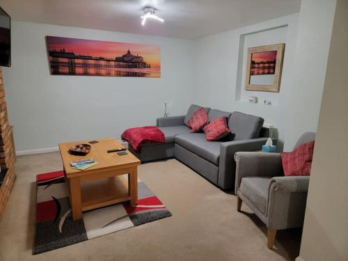 a living room with a couch and a table at Hidden Gem in Eastbourne