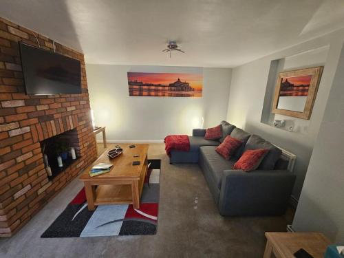 a living room with a couch and a fireplace at Hidden Gem in Eastbourne