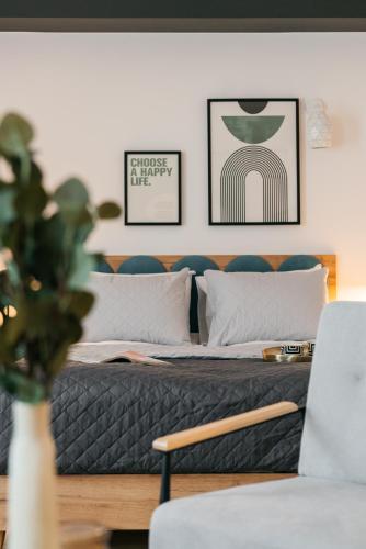 a bedroom with two beds and a couch at ORSO Rooms & Apartments - LoftAffair Collection in Warsaw