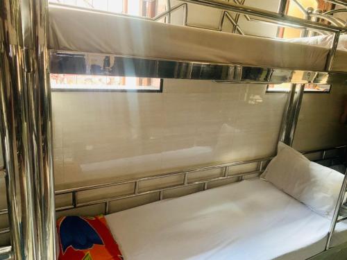 a bunk bed on a train with a window at Hotel BH residency in Mumbai