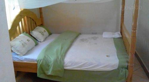 a bunk bed with two pillows on top of it at Trinity Guest House in Jinja