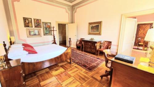 a bedroom with a bed and a desk at Castello di Lispida in Monselice