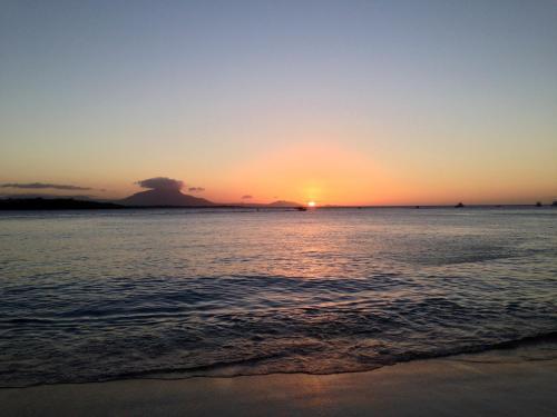 a sunset on the beach with the ocean at Royal Residence Apartment Condos in Cabarete