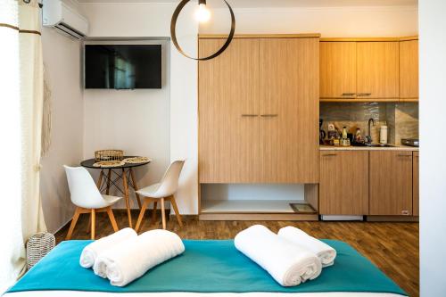 a room with a bed with two towels on it at Margo Cozy Houses in Mavrovouni