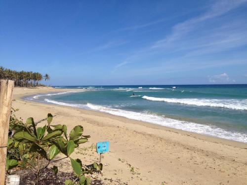a person surfing in the ocean on a beach at Royal Residence Apartment Condos in Cabarete