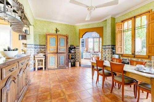 a large kitchen with a table and chairs at Finca Almenara de Copau in Zaragoza