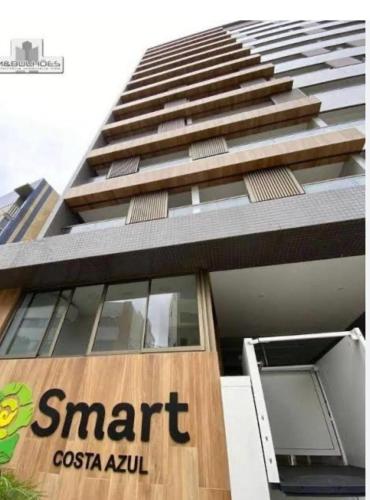 a tall building with a smart costa akul sign on it at New Studios by VLV Stays in Salvador