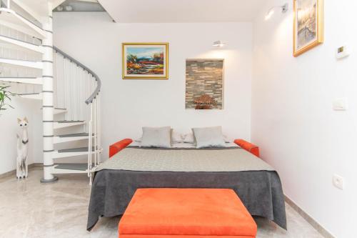 a bed in a room with a staircase at Apartment Nonna Laura in Portorož