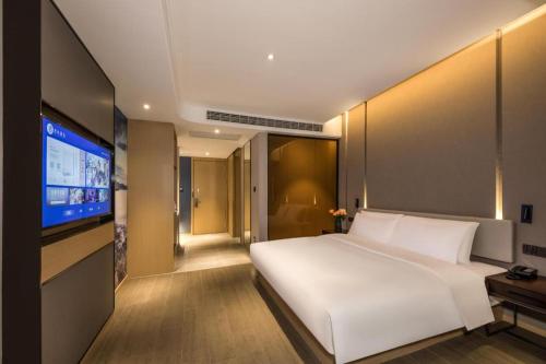 Krevet ili kreveti u jedinici u okviru objekta Hanting Premium Hotel Lianyungang Railway Station