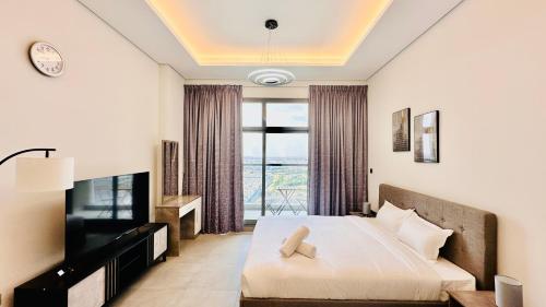 a hotel room with a bed and a television at Luxury Studio Apartments Business Bay With Balcony and Free parking by Belvilla in Dubai