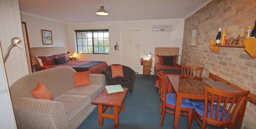 a living room with a couch and a table at Port Arthur Villas in Port Arthur