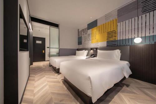 Cama o camas de una habitación en NIHAO Hotel Wuhan Hankou Jiangtan