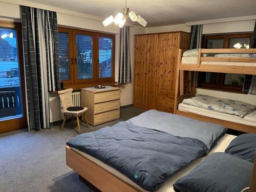 a bedroom with two bunk beds and a desk at Spacious holiday home in Niedernsill in Niedernsill
