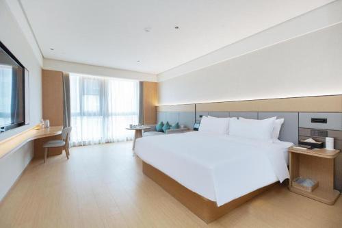 Кровать или кровати в номере JI Hotel Wenzhou Ouhai District Government