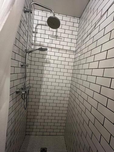 a bathroom with a shower with white subway tiles at Hótel Goðafoss Fosshóll in Godafoss