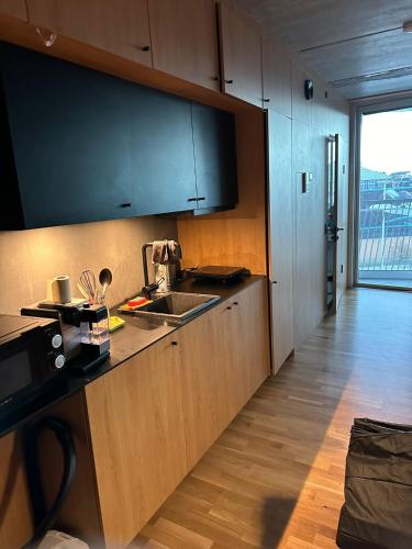 a kitchen with a sink and a counter top at Central apartment in Copenhagen