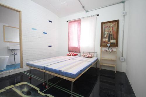 a bed in a room with a window at Time Travelers Party Hostel In Hongdae in Seoul
