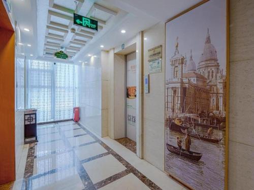 a hallway in an office with a painting on the wall at Vienna Hotel Hunan Liuyanghe Daqiao in Liuyang