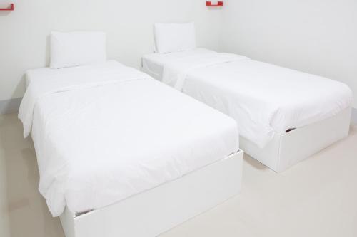 Postel nebo postele na pokoji v ubytování Honghub Sakon Hotel