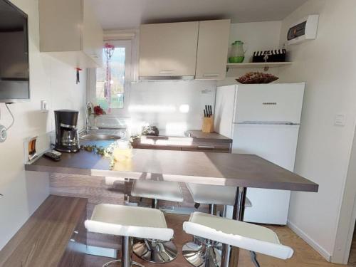 a kitchen with a counter and some white appliances at Tranquil Mobile Home at Ossiacher See in Tratten