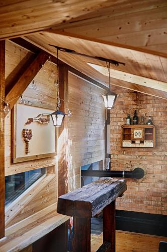 a room with a table and a brick wall at Olive Tree Forest Cabin Original in Kismaros