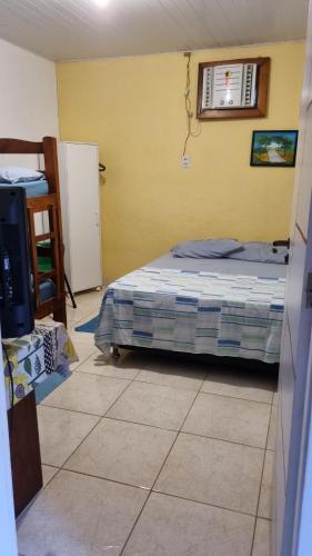 a bedroom with a bed and a air conditioner at Pousada da Didi in Belém