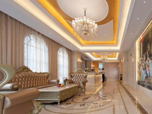 a living room with a couch and a chandelier at Vienna Hotel Hunan Chenzhou Municipal Government in Chenzhou