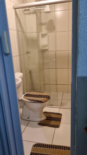 a bathroom with a toilet and a shower at Pousada da Didi in Belém