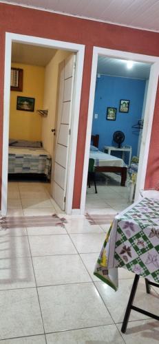 a room with a door and a room with a bed at Pousada da Didi in Belém
