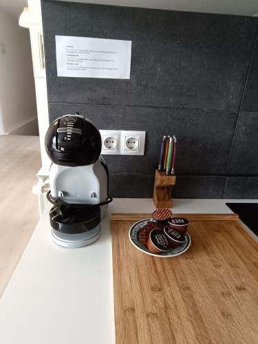 a coffee maker on a counter with a plate of cookies at Plena naturaleza en Pleno San Sebastián in Donostia-San Sebastián