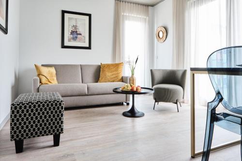 a living room with a couch and a table at Hotel BalthazarS in Seligenstadt