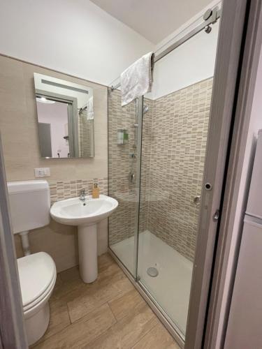 a bathroom with a toilet and a sink and a shower at Le Colonne del Massimo Apartment in Palermo