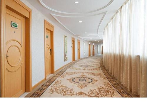 a corridor of a hotel with a long hallway at Vienna Hotel Guangdong Jiangmen Yingbin Avenue in Jiangmen