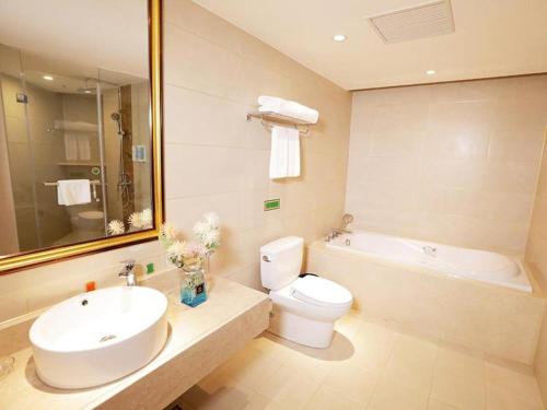 een badkamer met een wastafel, een toilet en een bad bij Vienna Hotel Shenyang Central Street in Shenyang