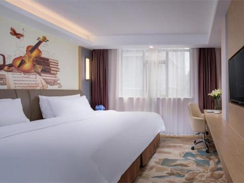 Llit o llits en una habitació de Vienna Hotel Nanning Beihu Metro Station