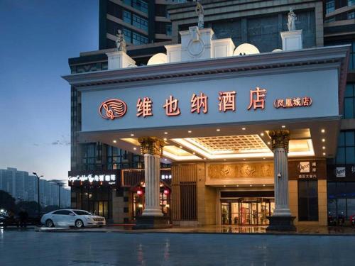 a building with a sign on the front of it at Vienna Hotel Jiangsu Kunshan Changjiang North Road Fenghuangcheng in Kunshan