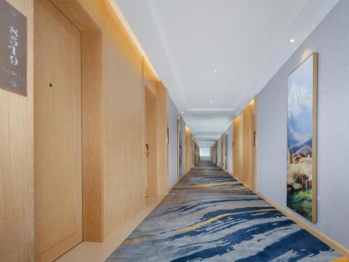 a hallway with a painting of waves on the floor at Vienna Hotel Baoshan Yongchang Road in Baoshan