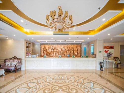 a large lobby with a chandelier in a building at Vienna Hotel Tianjin Zhongbei Town in Caozhuang