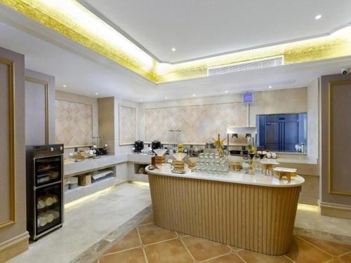a large kitchen with a large island in the middle at Vienna Hotel Jiangxi Shangrao High-Speed Railway Station in Shangrao