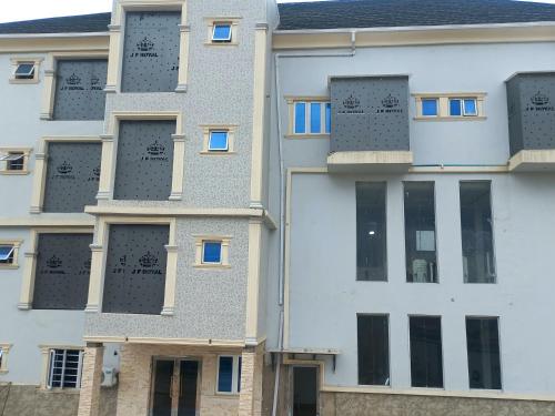 an external view of a building with windows at JF Royal Hotel & Suites in Ogbomoso