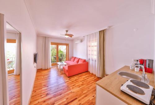 a living room with a red couch and a table at Yoga House Kaş in Kaş