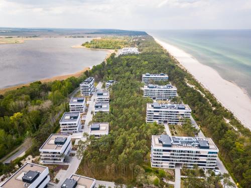 an aerial view of a beach with condos at Apartament na Sosnowej Wydmie - Osiedle Shellter in Rogowo